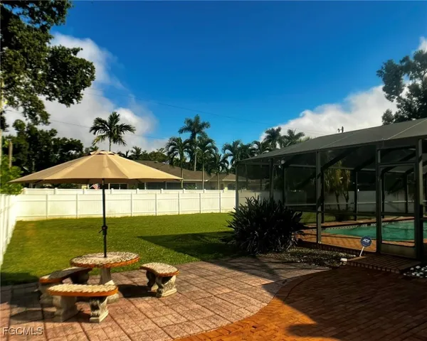 a view of a table and chairs under an umbrella