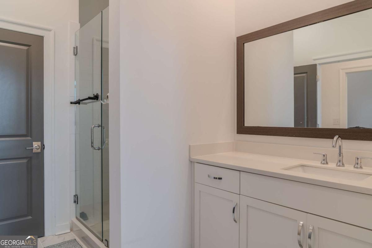 133 Devore Road, Unit 208 Alpharetta, GA 30009 - Photo 13 of 20 a bathroom with a sink and a mirror