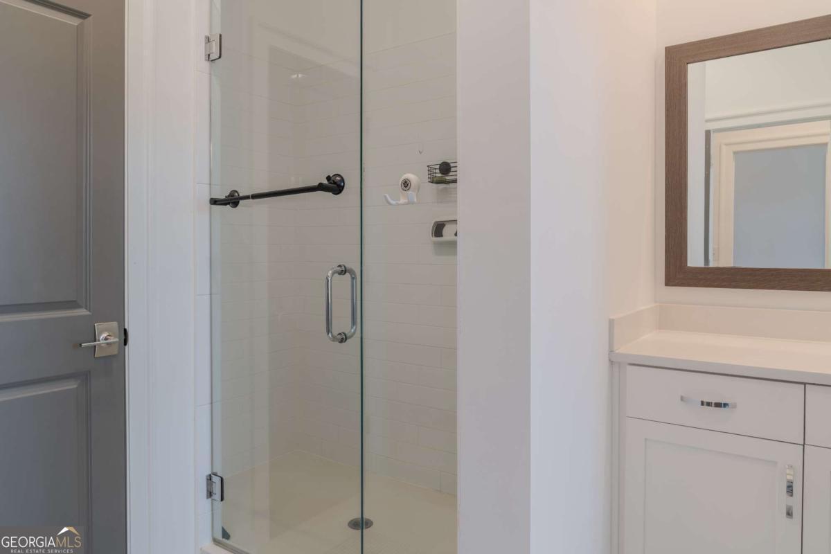133 Devore Road, Unit 208 Alpharetta, GA 30009 - Photo 14 of 20 a bathroom with a shower sink and mirror