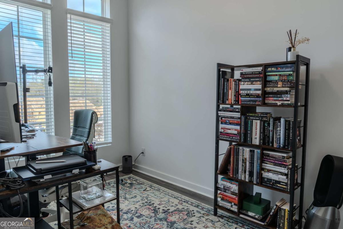 133 Devore Road, Unit 208 Alpharetta, GA 30009 - Photo 15 of 20 a view of a workspace with furniture and a book shelf