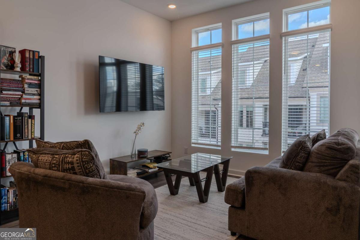 133 Devore Road, Unit 208 Alpharetta, GA 30009 - Photo 3 of 20 a living room with furniture and a window