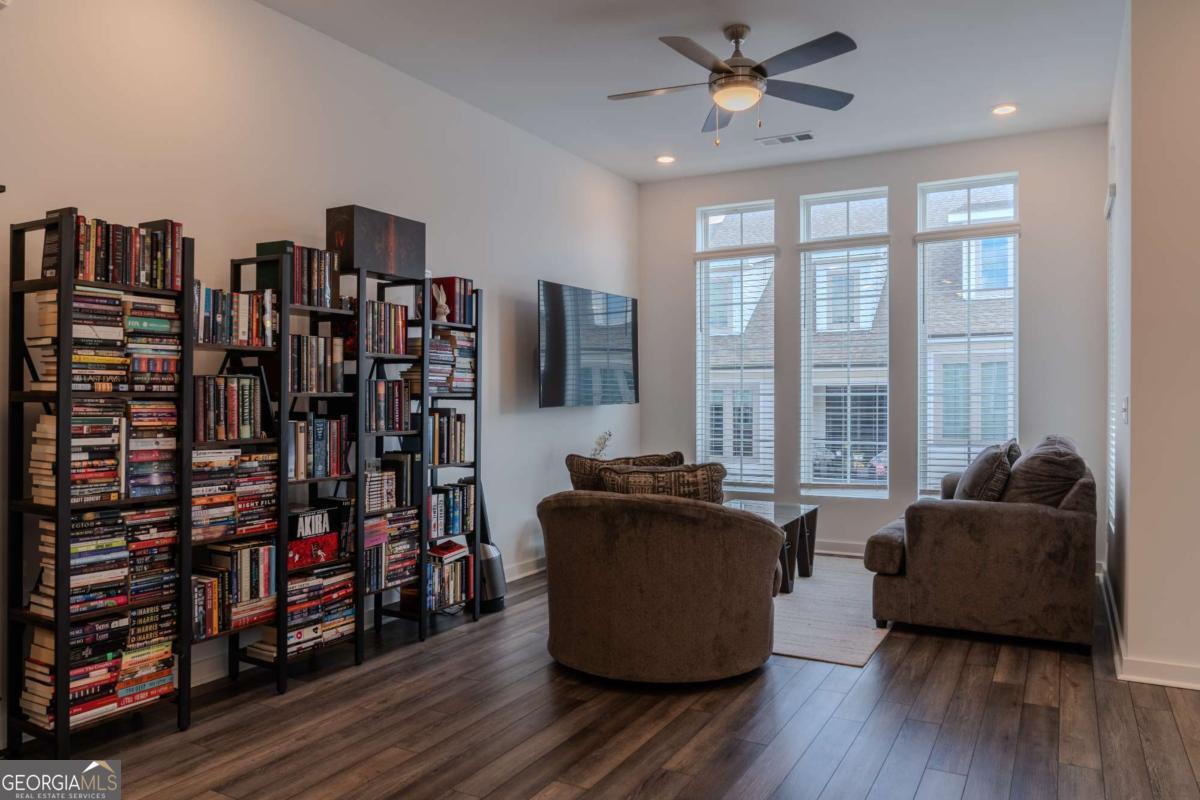 133 Devore Road, Unit 208 Alpharetta, GA 30009 - Photo 4 of 20 a living room with furniture a flat screen tv and a bookshelf