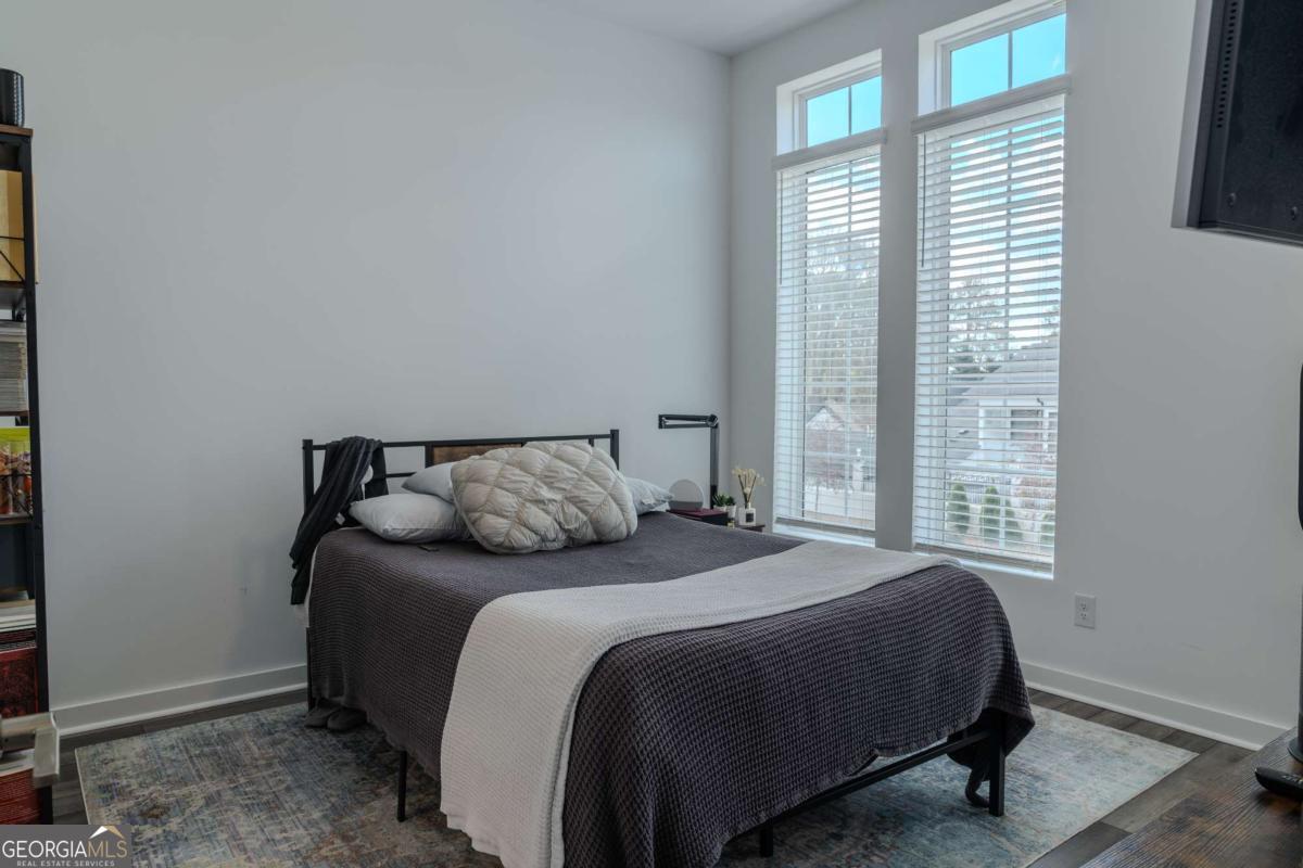 133 Devore Road, Unit 208 Alpharetta, GA 30009 - Photo 10 of 20 a bedroom with a bed and a window