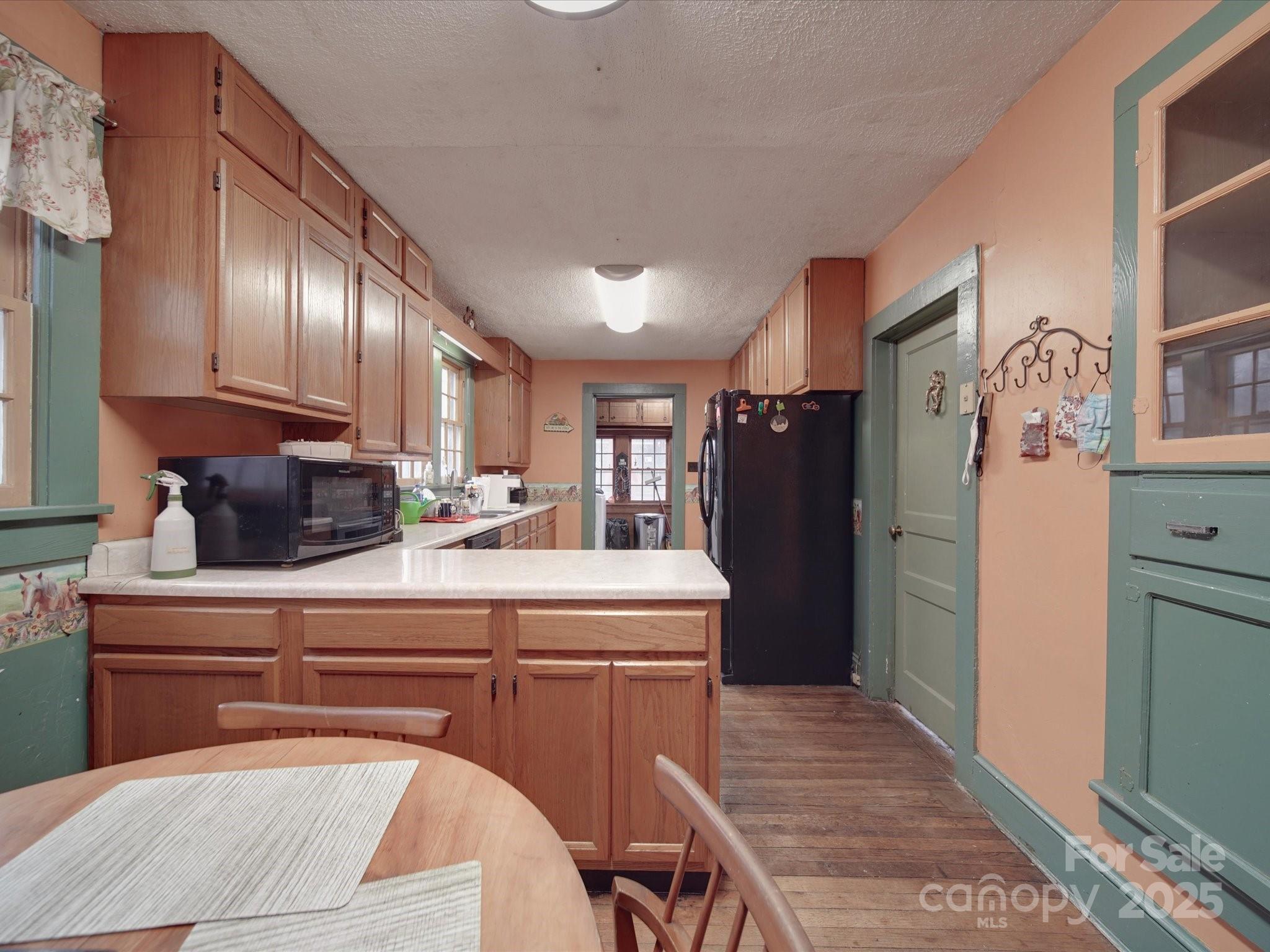 1231 Cherry Hill Road Mocksville, NC 27028 - Photo 11 of 31 a kitchen with kitchen island a counter top space a refrigerator and cabinets