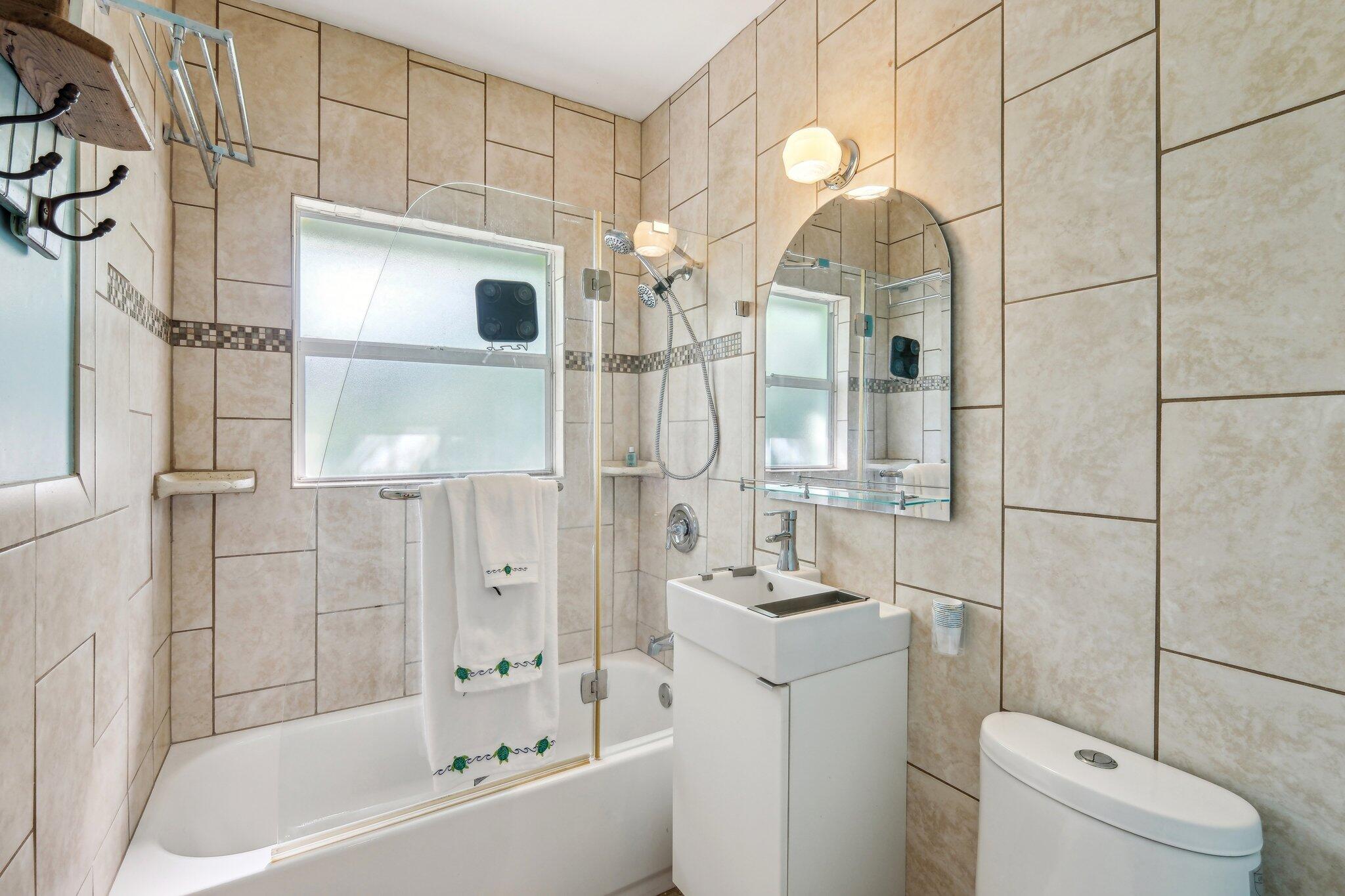 1006 Casuarina Road, Unit 11 Delray Beach, FL 33483 - Photo 16 of 19 a bathroom with a sink a toilet and shower