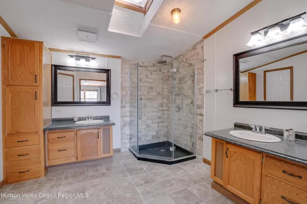 a bathroom with a granite countertop sink a mirror and a