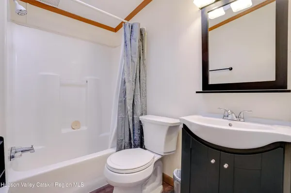 a bathroom with a sink toilet and mirror