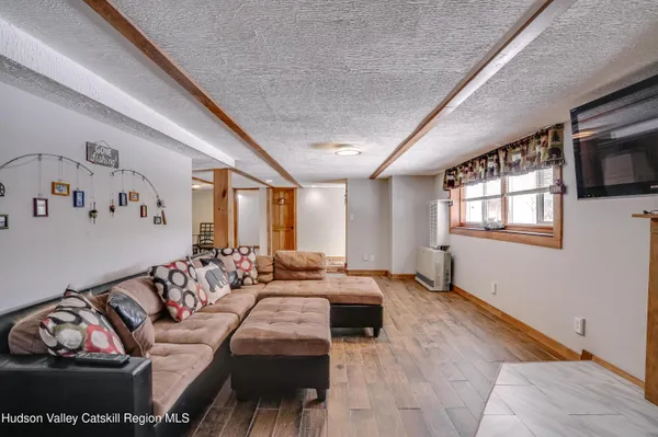 a living room with furniture fireplace and a window