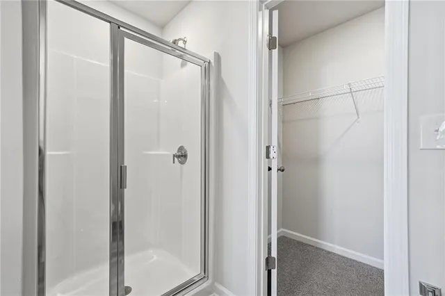 a bathroom with a glass shower door