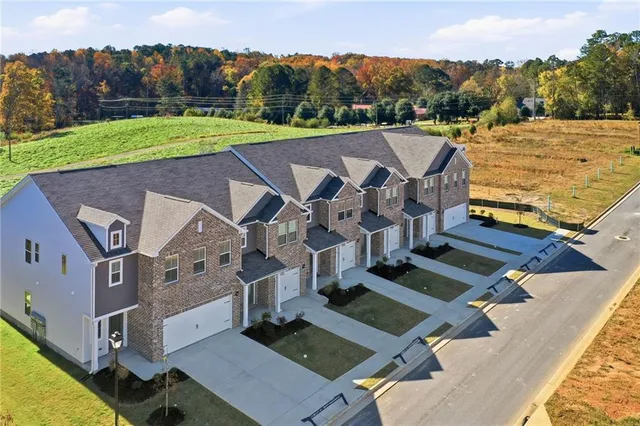 an aerial view of residential houses with outdoor space