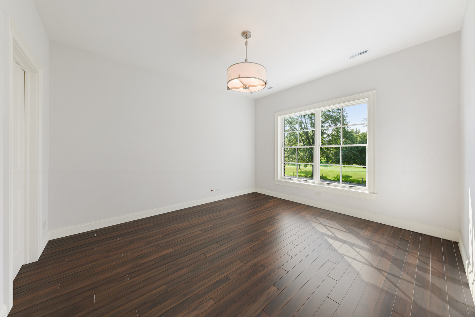 820 Country Club Road Crystal Lake, IL 60014 - Photo 29 of 48 an empty room with wooden floor cabinet and windows