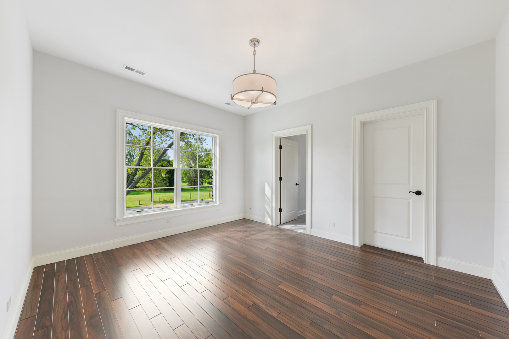 820 Country Club Road Crystal Lake, IL 60014 - Photo 31 of 48 a view of an empty room with wooden floor and a window