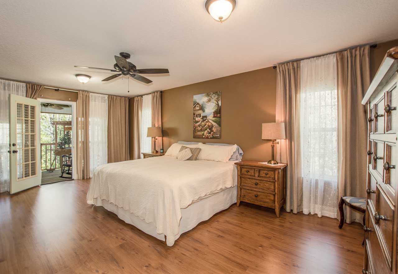 3233 Turtle Creek Road St. Augustine, FL 32086 - Photo 22 of 44 a bedroom with a large bed a flat tv screen and a walk in closet