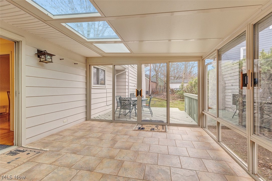 2990 Hampton Road Cleveland, OH 44120 - Photo 14 of 29 Sunroom / solarium featuring outdoor dining area, a skylight, and wood walls