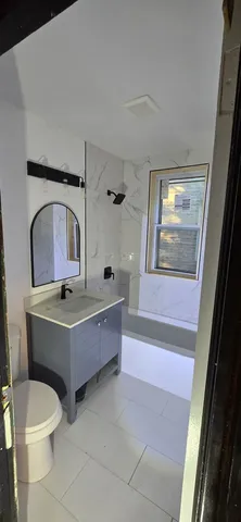 a bathroom with a tub toilet and sink