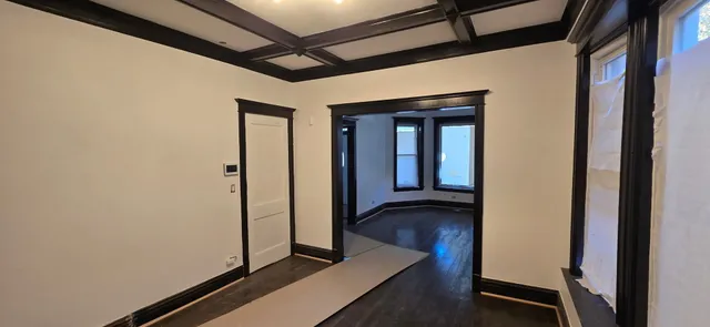 a view of hallway with wooden floor