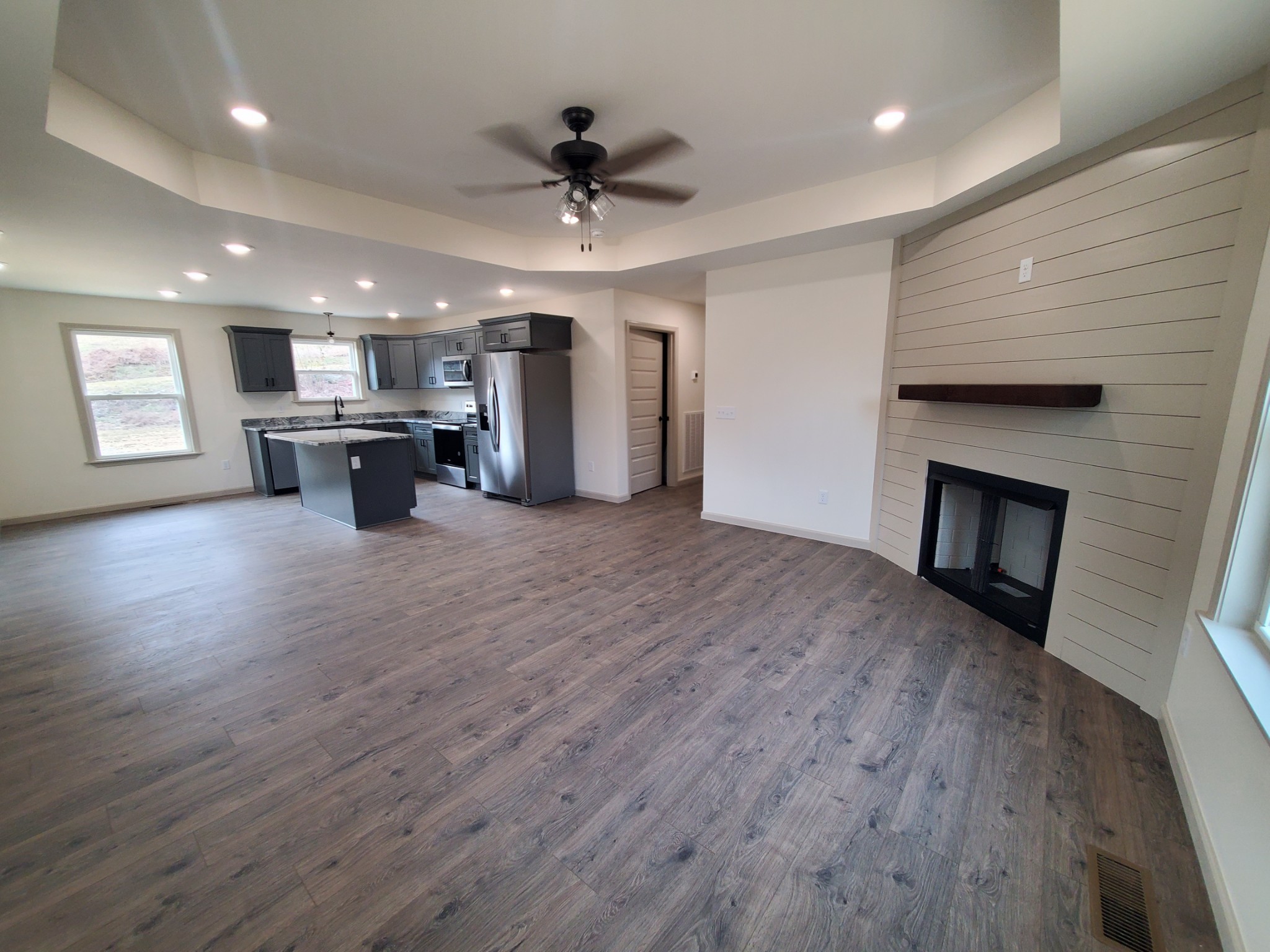 155 Fitzpatrick Road Buffalo Valley, TN 38548 - Photo 3 of 19 an empty room with wooden floor and kitchen view
