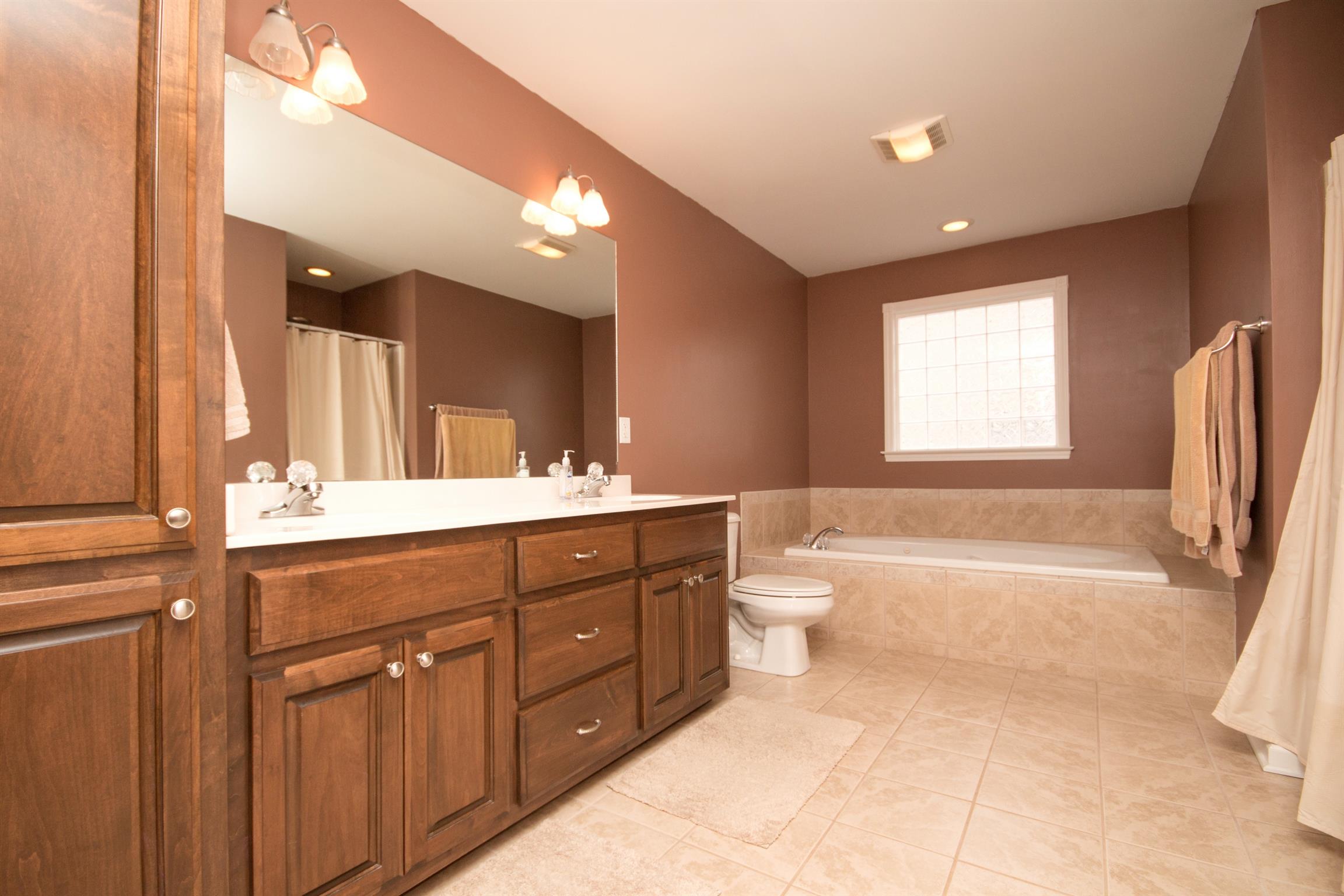 349 Freeland Road Portland, TN 37148 - Photo 8 of 24 a spacious bathroom with a tub sink double vanity and a mirror