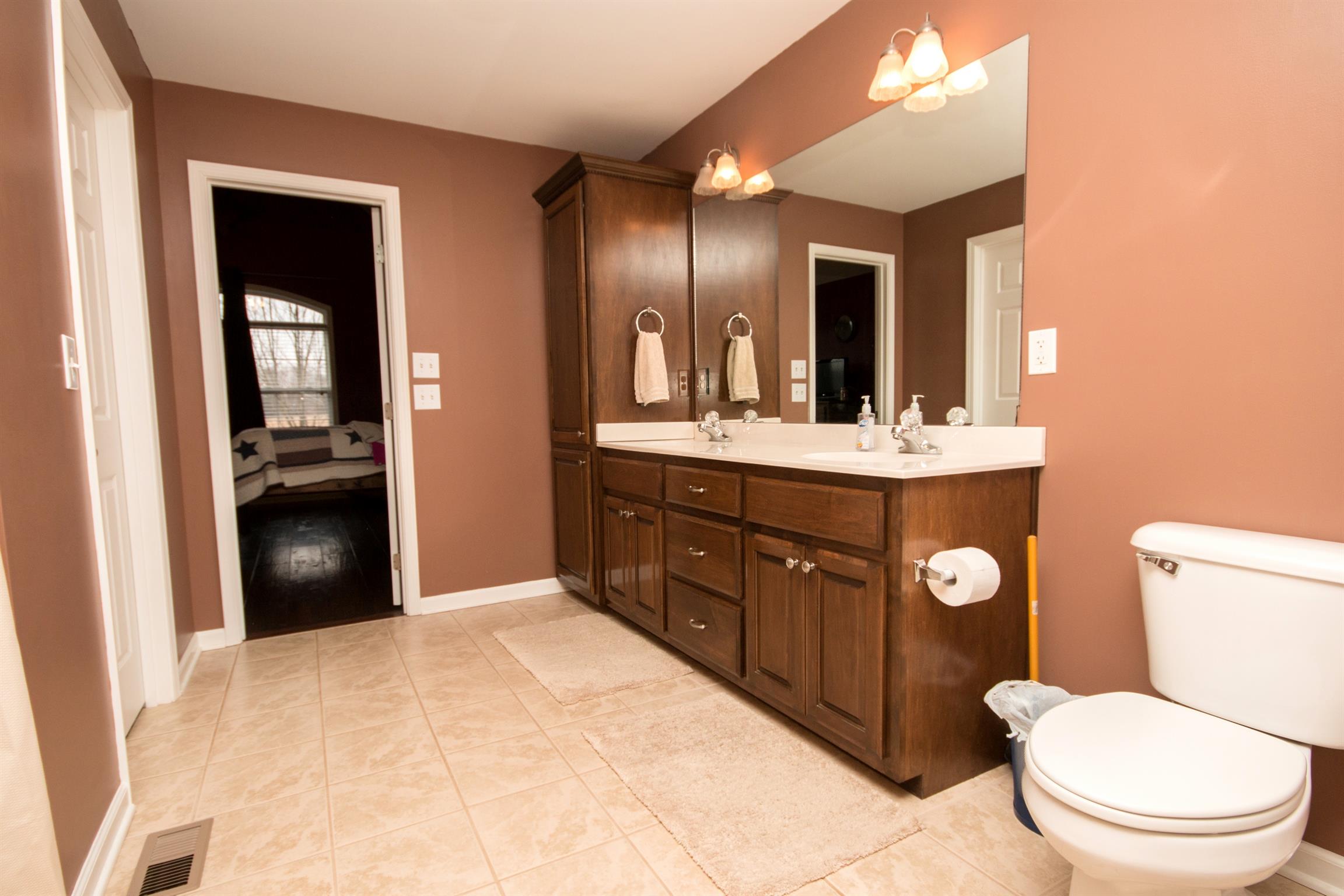 349 Freeland Road Portland, TN 37148 - Photo 9 of 24 a bathroom with a toilet a sink a vanity and mirror