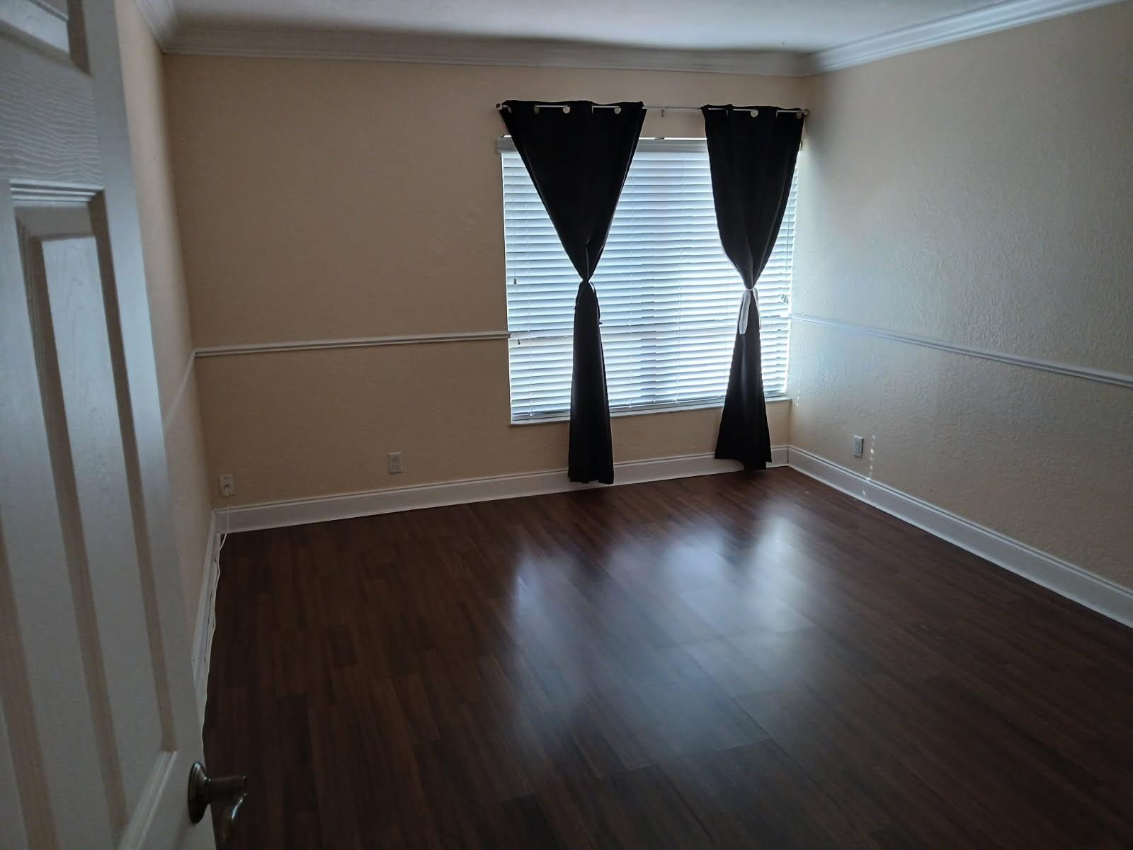 2339 Southwest 15th Street, Unit 19 Deerfield Beach, FL 33442 - Photo 8 of 15 an empty room with wooden floor and windows