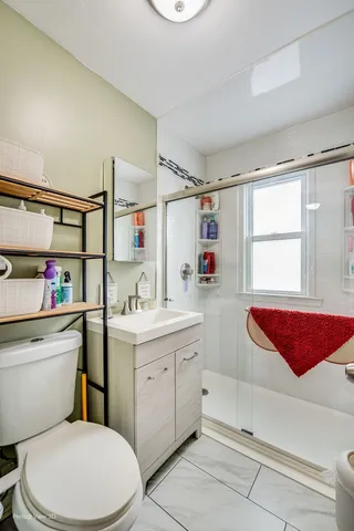 a bathroom with a sink a toilet and a shower