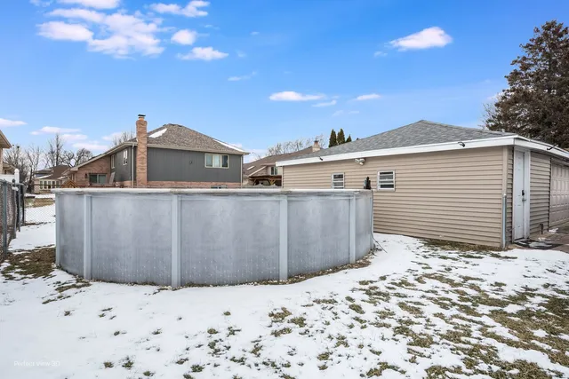 a view of a house with a snow in the background