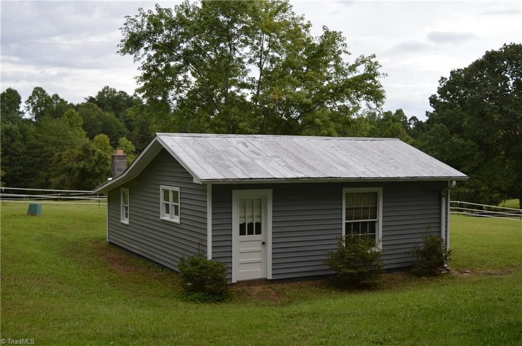 8392 West Harrell Road Oak Ridge, NC 27310 - Photo 2 of 23 Detached wired garage & workshop with woodstove.