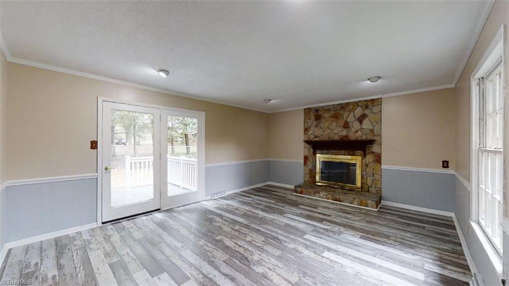 8392 West Harrell Road Oak Ridge, NC 27310 - Photo 10 of 23 Spacious den with wood burning fireplace & french door to NEW composite deck & fenced backyard.