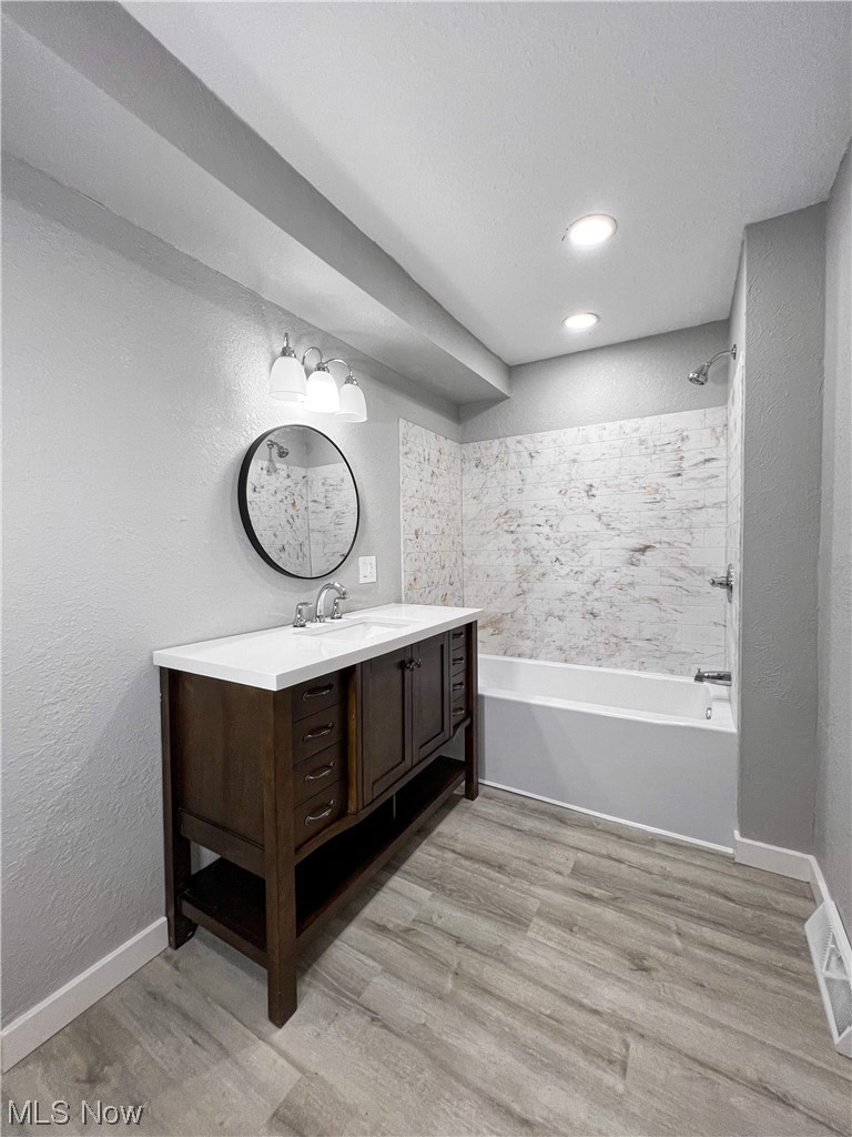 602 West Marshall Road McDonald, OH 44437 - Photo 14 of 19 Bathroom with tiled shower / bath, vanity, and wood-type flooring