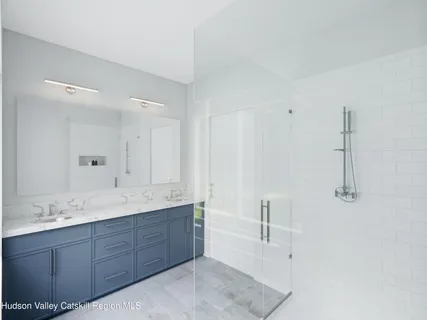 a spacious bathroom with a granite countertop sink mirror and double