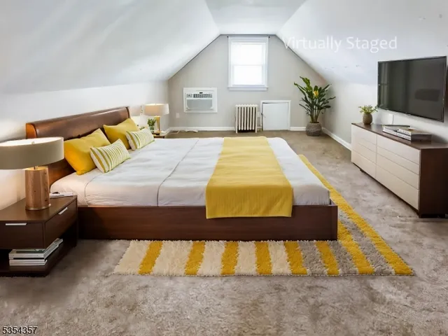 a bedroom with a bed and a flat screen television