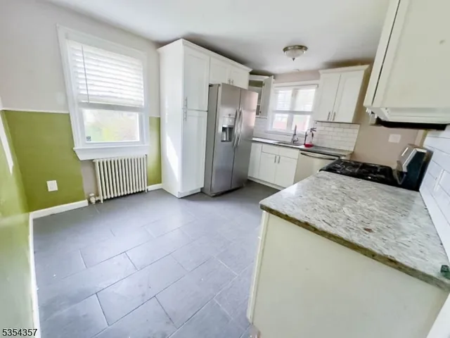 a kitchen with a refrigerator a sink dishwasher and a stove
