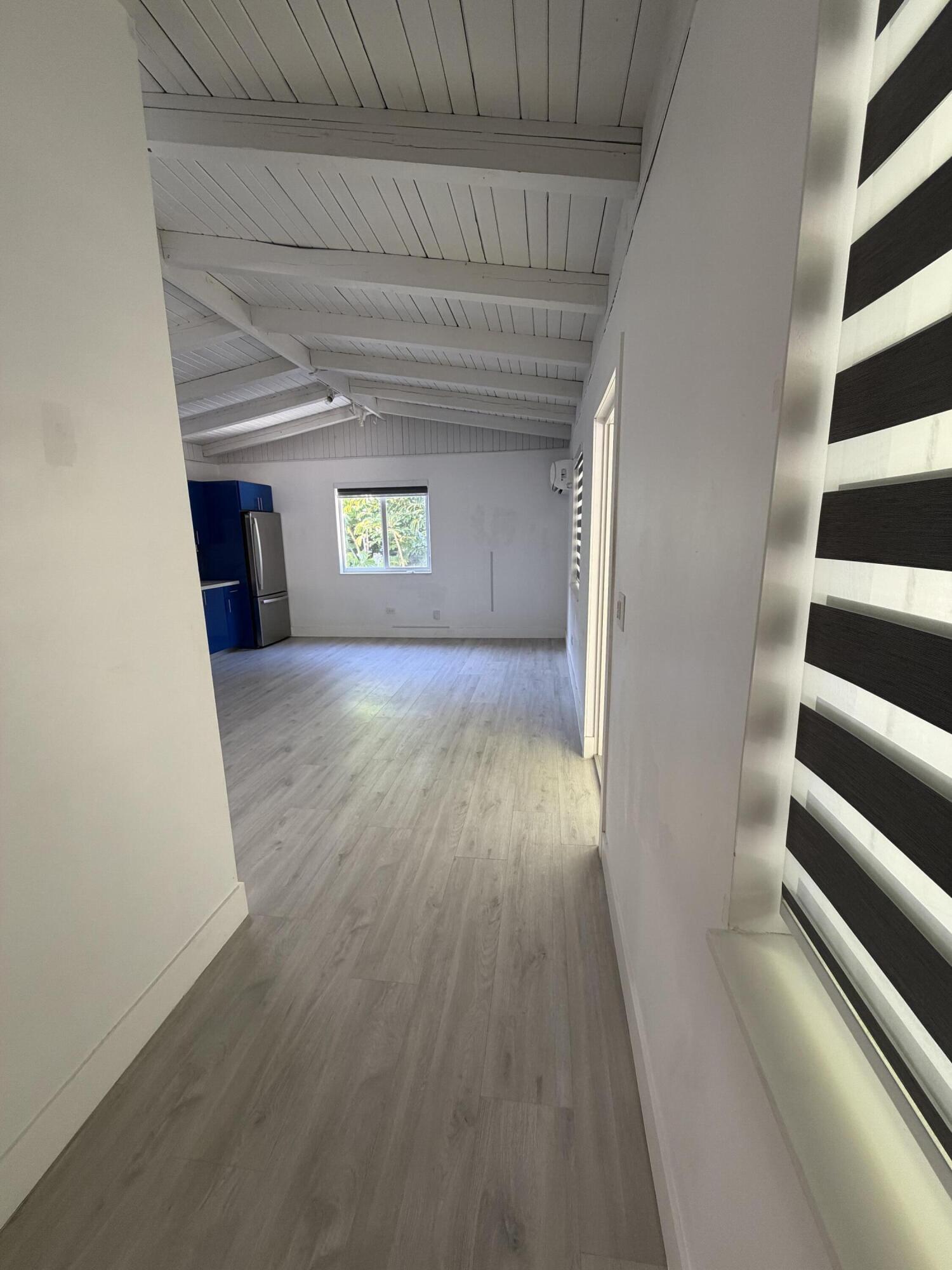 7 Sunset Road, Unit 5 Key Largo, FL 33037 - Photo 3 of 7 wooden floor in an empty room with a window