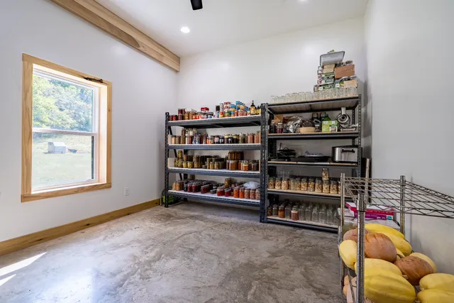 a bedroom with a bed and a large window with the outer view