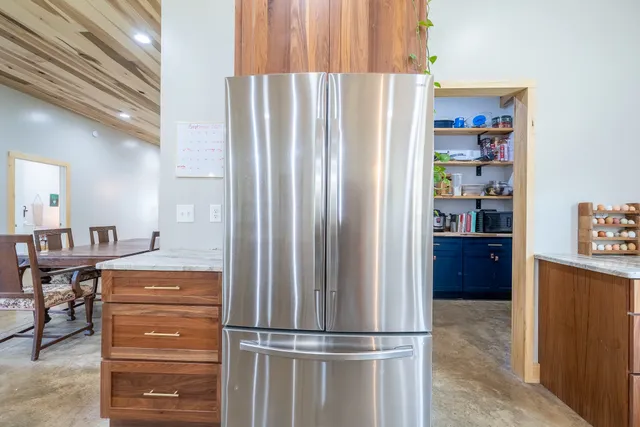 an aerial view of a house with a yard and lake view