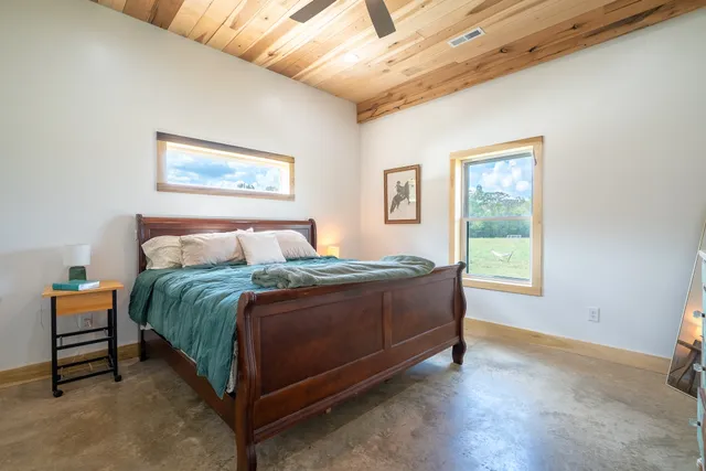 a living room with furniture a large window and a rug