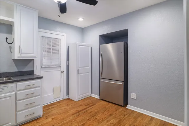 a kitchen with white cabinets and stainless steel appliances