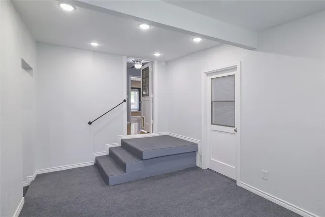a living room with furniture and stairs