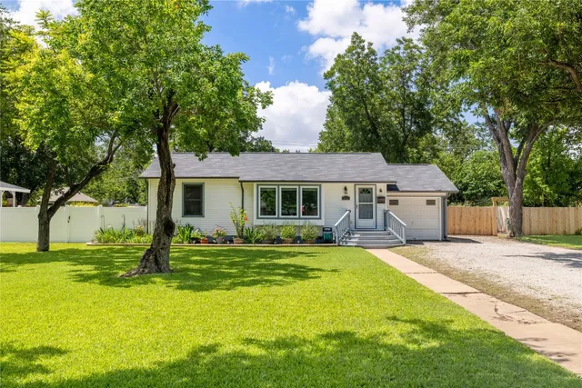 a front view of a house with a yard porch and outdoor seating
