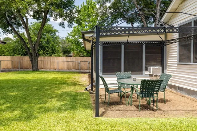 a view of a house with a backyard and a patio