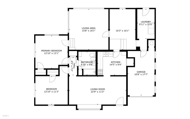 a living room with stainless steel appliances furniture and a kitchen view