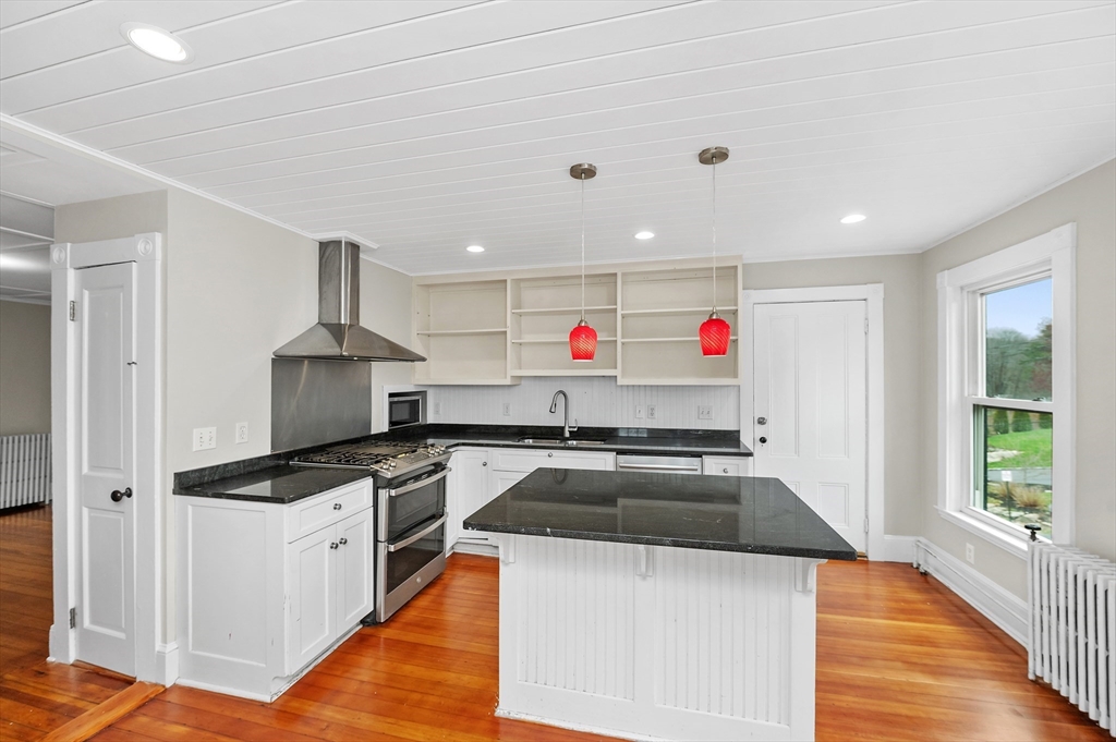 18 Bennett Street, Unit 2 Manchester, MA 01944 - Photo 2 of 21 a kitchen that has a stove and a microwave