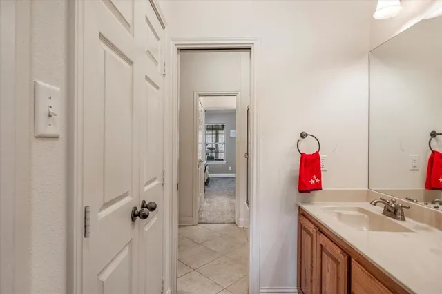 a bathroom with a sink vanity and mirror