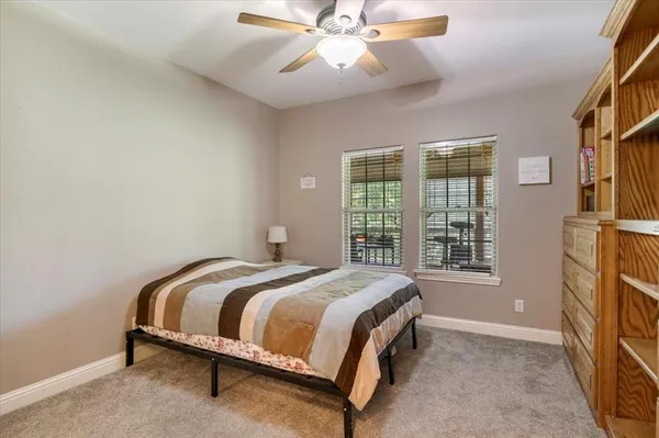 a bed sitting in a bedroom next to a window