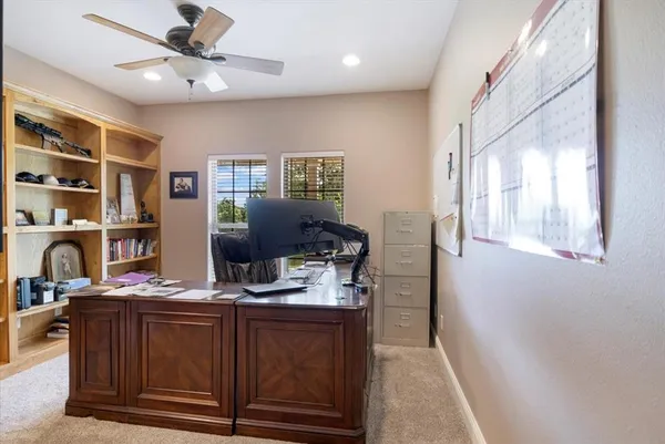 a workspace with furniture and bookshelf