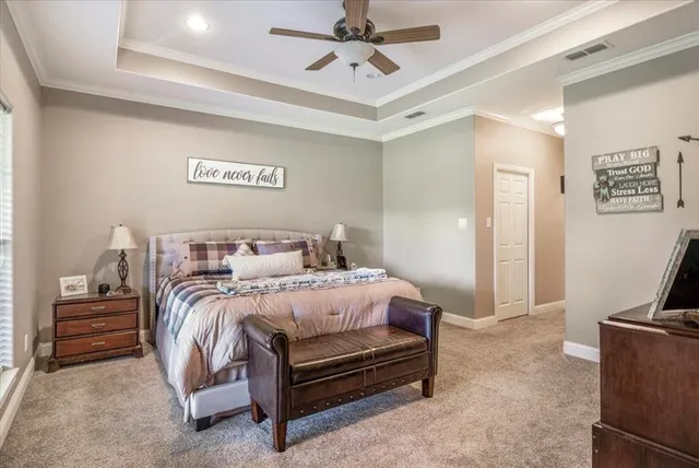 a bedroom with a bed and a ceiling fan