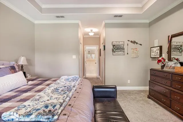 a bedroom with a bed and a dresser in it