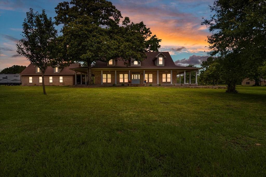 6299 Highway 271 Gilmer, TX 75644 - Photo 26 of 39 a front view of a house with a garden