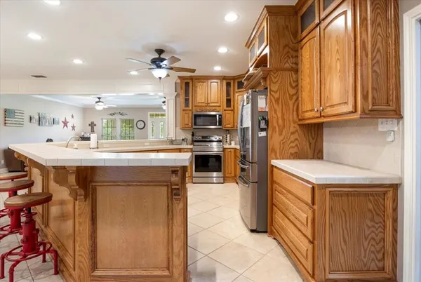 a kitchen with a sink appliances and cabinets