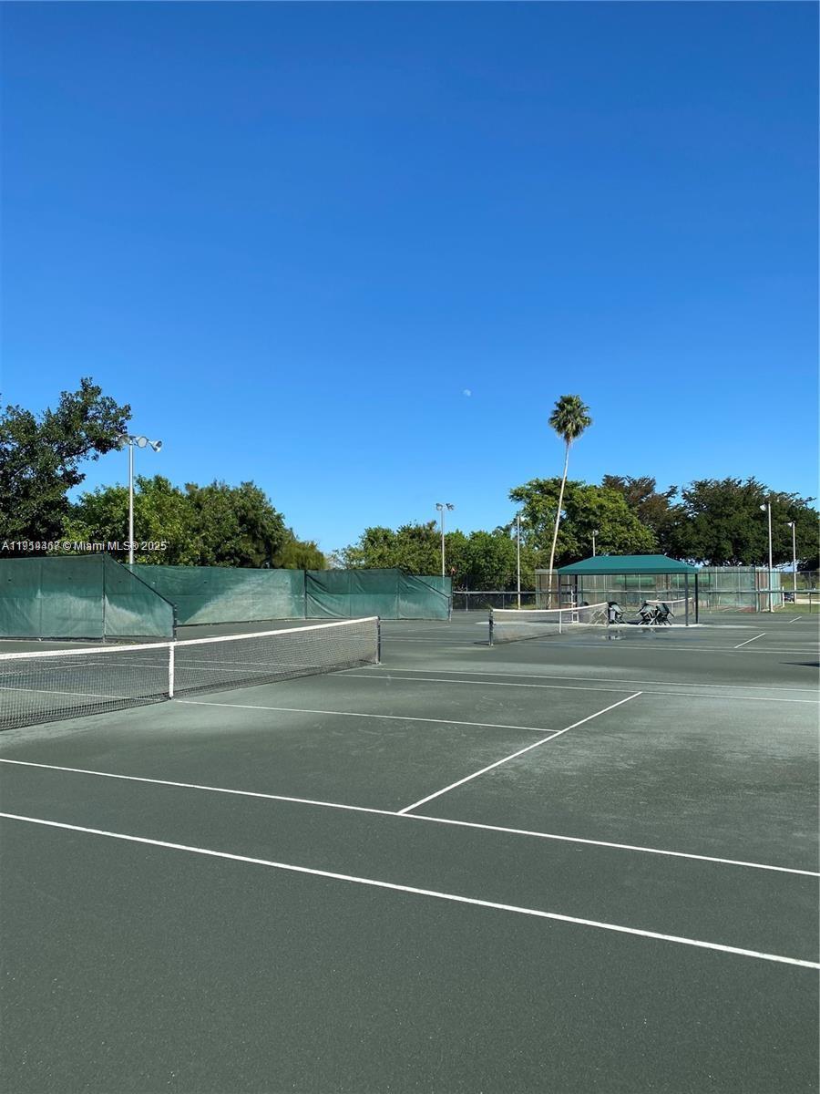 6935 Huntington Lane, Unit 107 Delray Beach, FL 33446 - Photo 18 of 23 a view of a tennis court